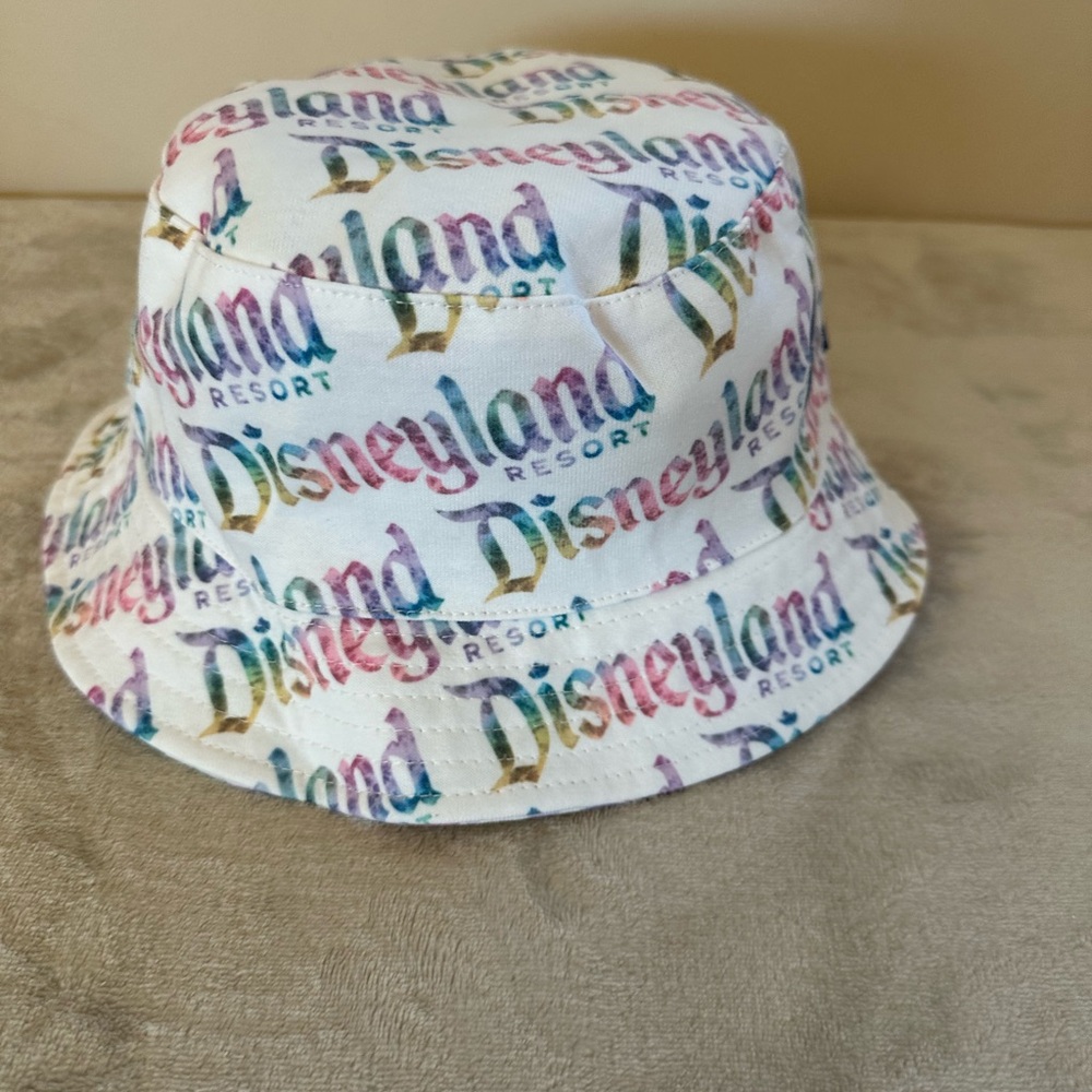 Reversible Disneyland bucket hat. White with pastel printed design.